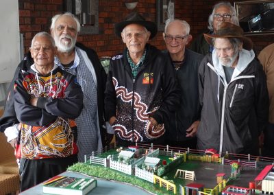 Uncle Les Franks (KBH survivor), shares stories with fellow survivors of his time at Kinchela Boys Home, around a scale model he has built of the home in the 1950s.